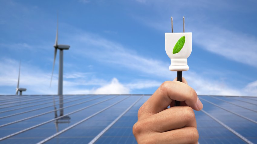 shutterstock eco power concept.hand holding green power plug and solar