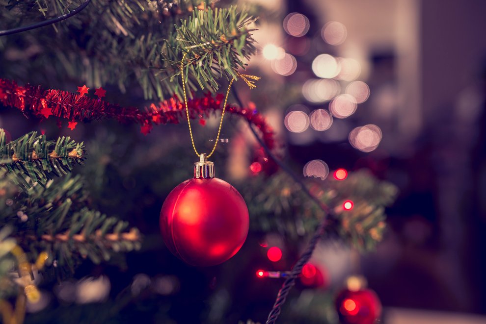 Closeup of red bauble hanging from Christmas tree
