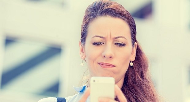 Closeup side profile portrait upset sad skeptical unhappy serious woman talking texting on phone