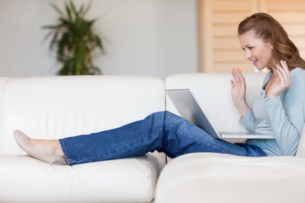 Excited young woman on the sofa