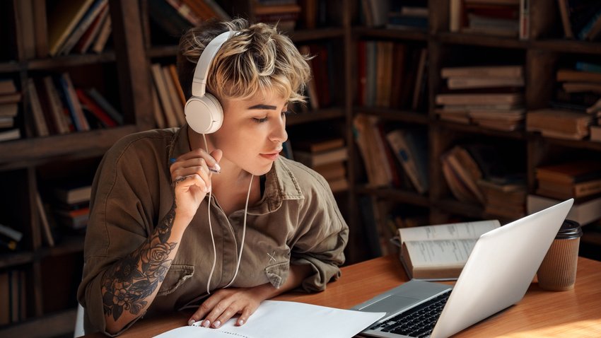 Concentrated and focused young adult behind a Laptop