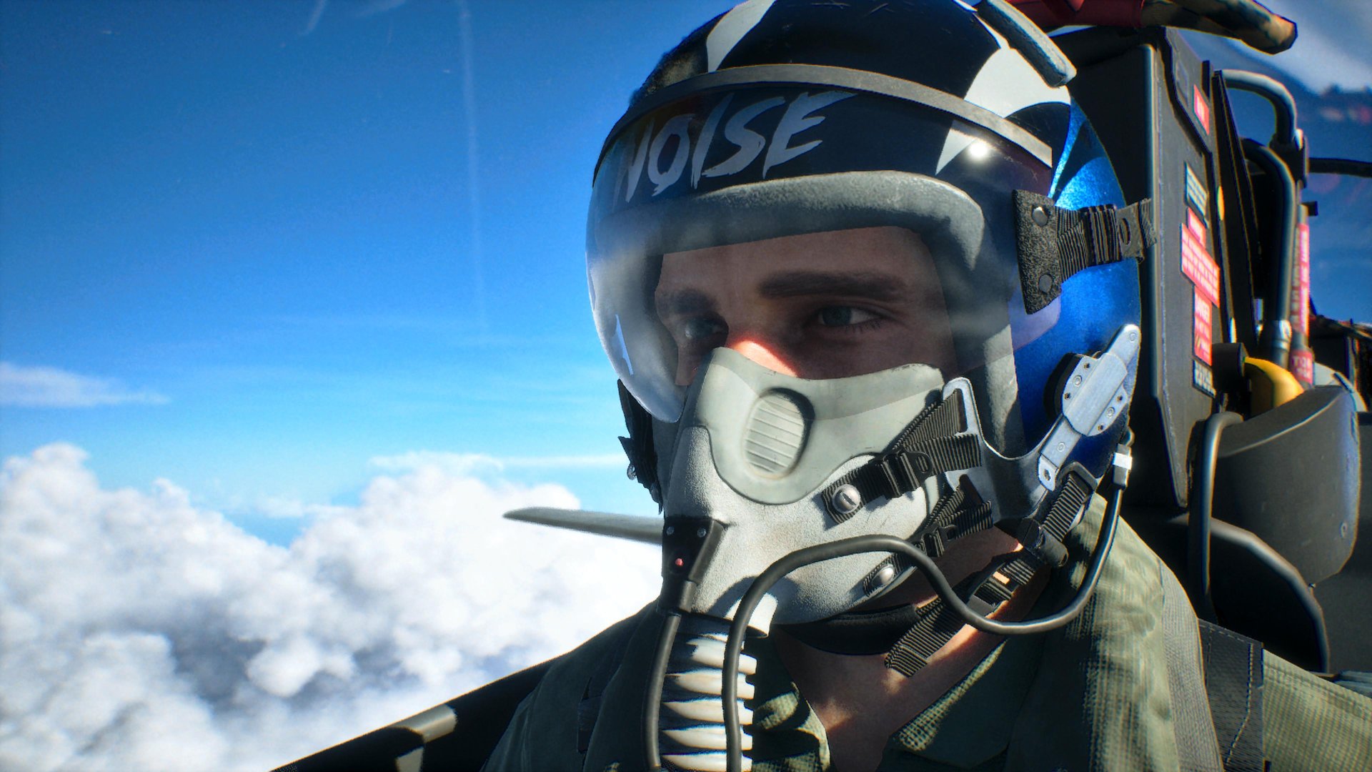Close-up of a pilot in a fighter plane wearing a helmet with the inscription