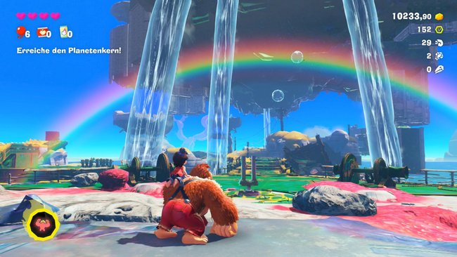 Blick auf die Spielwelt von Donkey Kong Bananza mit einem auffälligen Regenbogen.