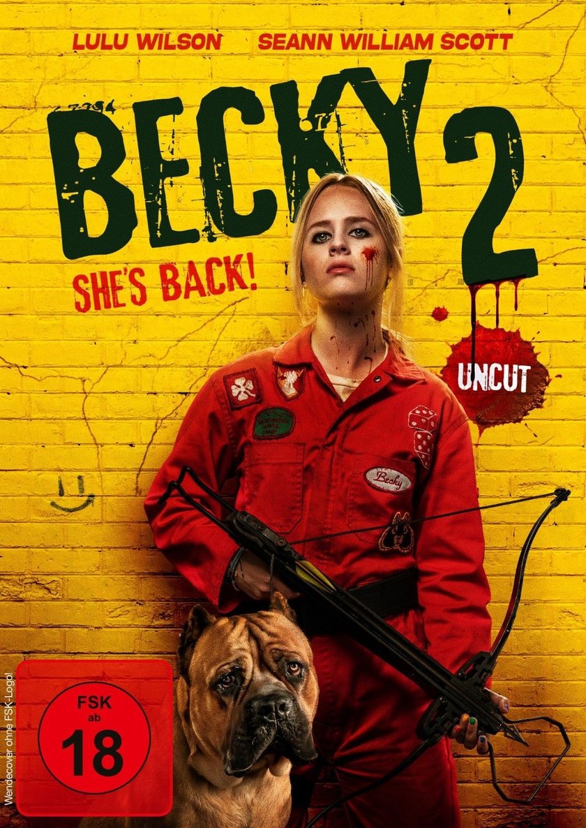 Filmplakat für „Becky 2“. Im Zentrum steht eine junge Frau in einem roten Overall, die eine Armbrust hält und blutverschmierte Spuren im Gesicht und am Hals aufweist. Über ihr steht der Titel „BECKY 2 SHE'S BACK. Links unten ist ein großer Hund zu sehen.