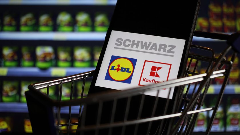 Viersen, Germany - May 9. 2020: Close up of mobile phone screen in shopping cart modell with logo lettering of german Schwarz group supermarket chain (focus on center of lidl logo)