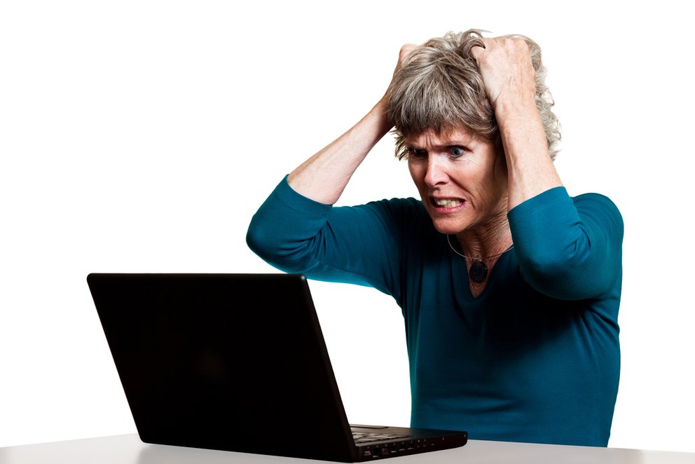 Frustrated computer user tearing out her hair