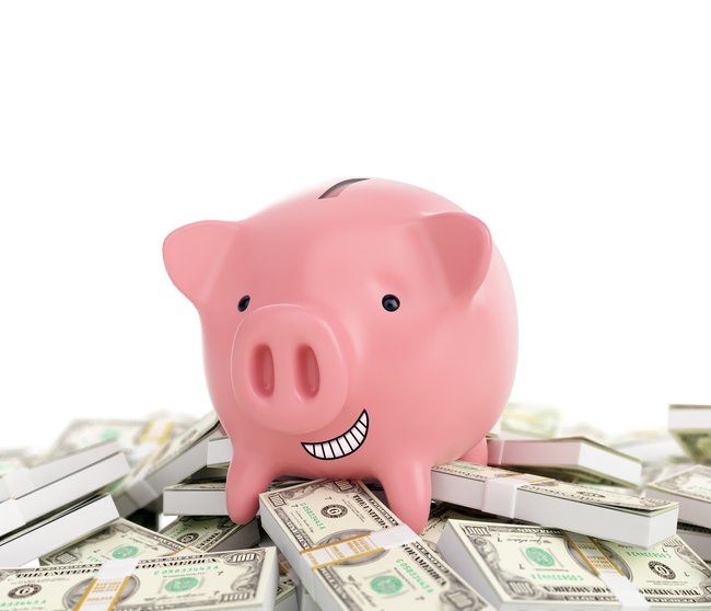 Smiling piggy bank standing on a pile of money