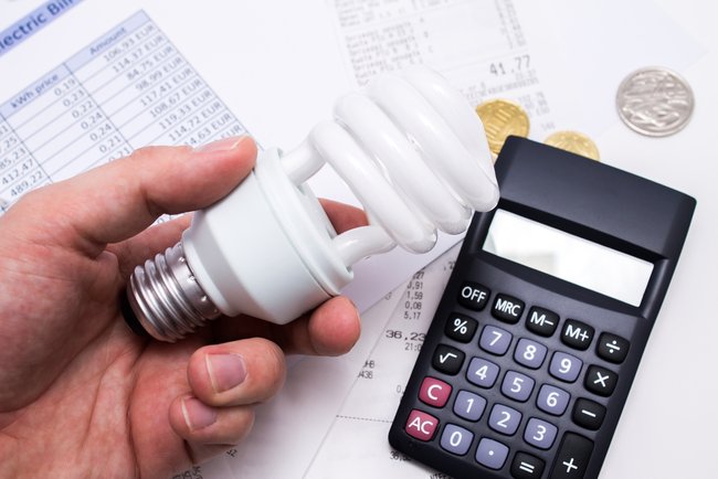 Light bulb whit calculator and coins