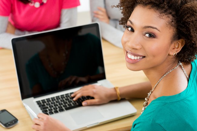 Close-up Of Happy Student Working On Laptop