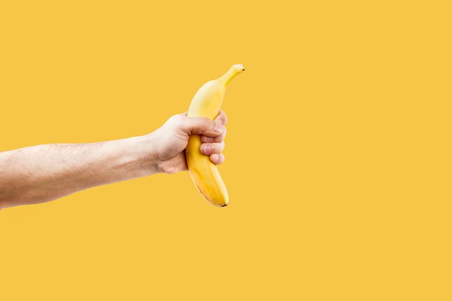 Hand male holding a shape banana telephone.