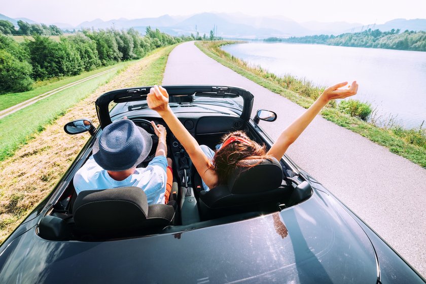 Couple in love ride in cabriolet car