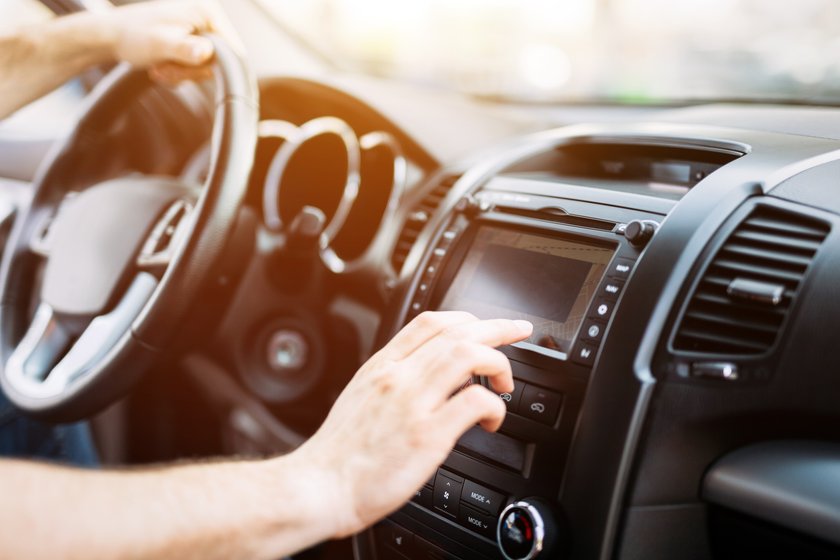 Man using navigation system while driving car