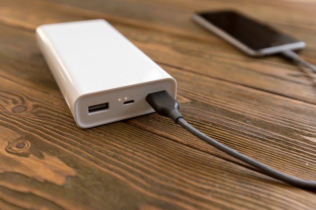 powerbank and cellphone on wooden table