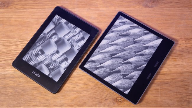 Auf einem Tisch liegen nebeneinander die E‑Book-Reader Kindle Paperwhite und Kindle Oasis.