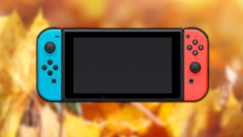 Eine Nintendo Switch wird gezeigt, sie befindet sich vor einem Haufen gelber Blätter.