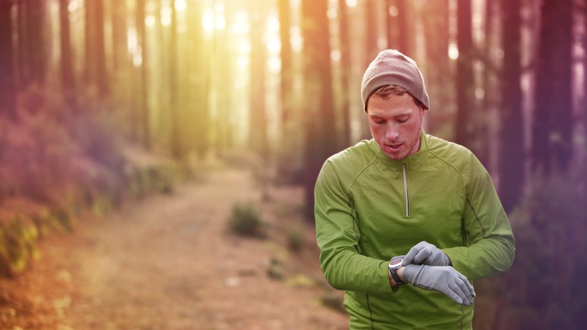 Jogger im Wald mit Smartwatch