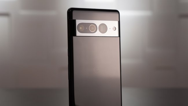 The smartphone Google Pixel 7 Pro stands on a table with the back to the camera.