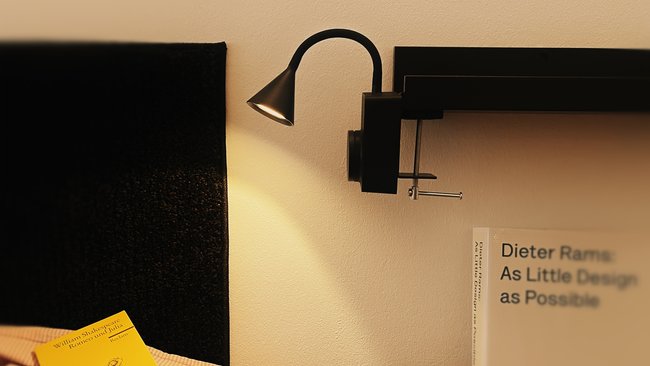 LED light Ikea Tågvirke as a bedside lamp next to a bed.