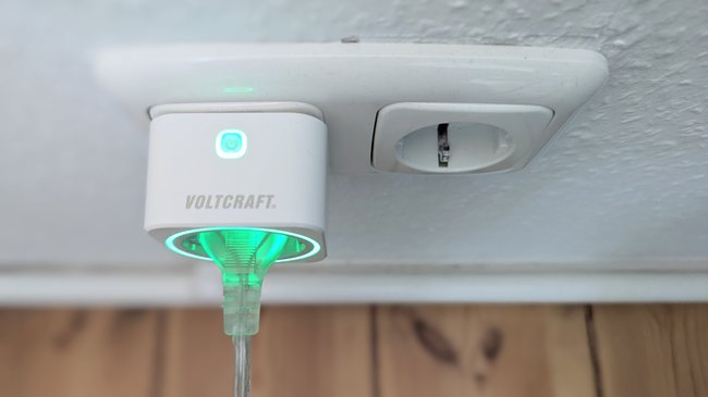 In einer Steckdose steckt ein smarter Strommessstecker der Marke Voltcraft.