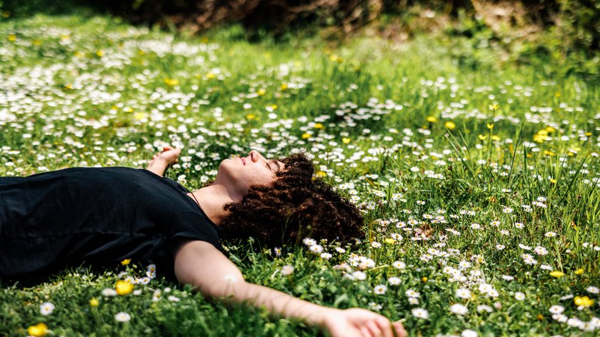 Boy with curly hair enjoys springtime in nature