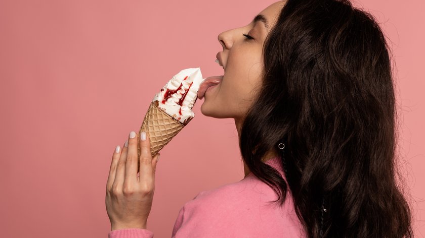 Side view of a woman licking a tasty vanilla ice cream in the waffle cone during the studio photo shoot on the pink background Model Released Property Released xkwx beautiful brunette eat appetizing sundae eyes closed lick vanilla ice cream waffle cone tasty camera studio photo shoot pink background favorite sweet food consumption dessert treat unhealthy eating unhealthy food snack nutrition nourishment high-carb sugar carbs carbohydrate sugar craving calorie hungry sweet tooth woman lady one person young caucasian dark-haired indoors studio photo self-indulgence modern lifestyle concept side view enjoy