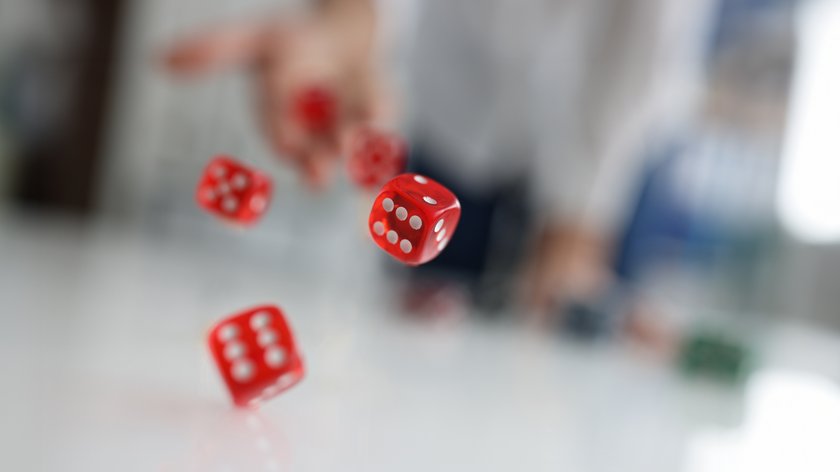 Woman hand throws red dice into air. Good luck gambling bet risk luck win concept